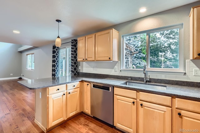 1616 Cedarwood Dr, Longmont, CO 80504 - kitchen featuring stainless steel dishwasher, a peninsula, light brown cabinetry, light wood finished floors, and dark stone countertops