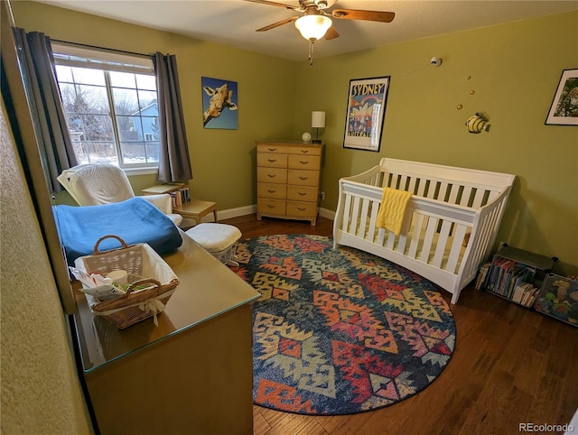 1616 Cedarwood Dr, Longmont, CO 80504 - bedroom featuring wood finished floors, a crib, and ceiling fan