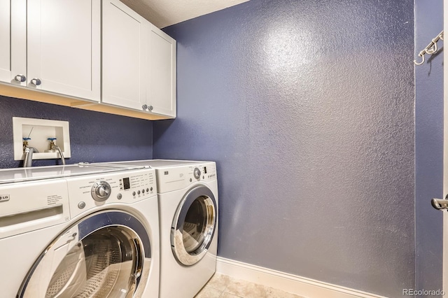 1616 Cedarwood Dr, Longmont, CO 80504 - laundry room featuring cabinet space, washing machine and dryer, light tile patterned floors, and a textured wall