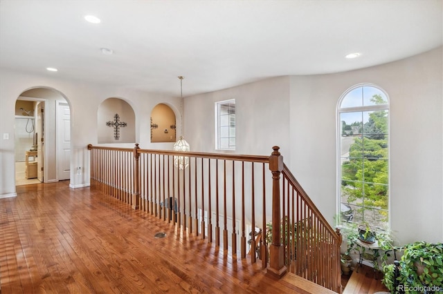 corridor with hardwood / wood-style flooring