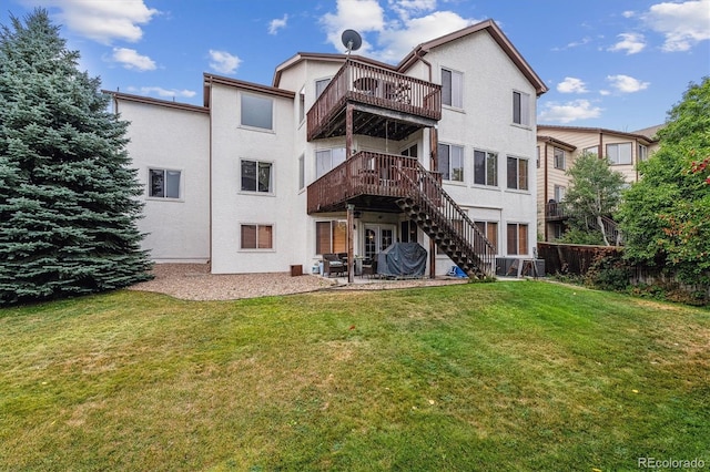 rear view of house featuring a lawn and a patio