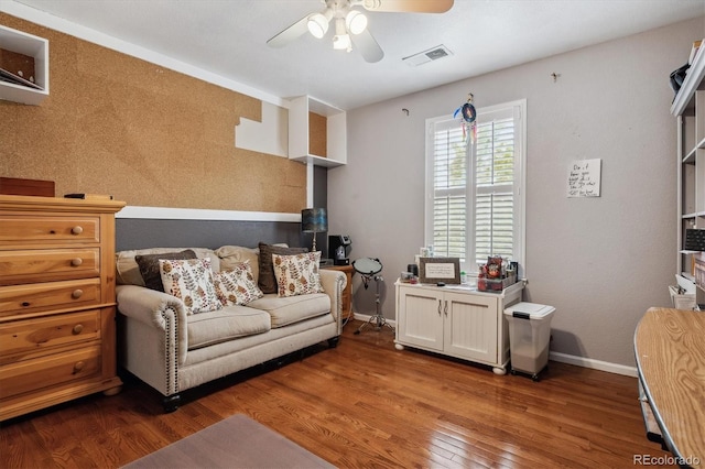 living area with ceiling fan and wood-type flooring