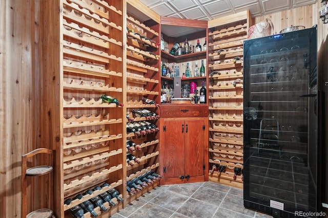 wine area with wine cooler and tile patterned floors