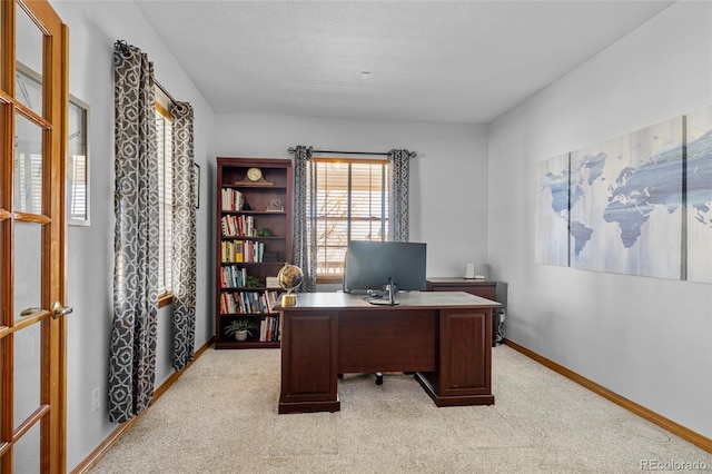 office area with light carpet and baseboards