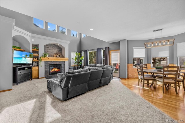 living area featuring a glass covered fireplace and light wood-style floors