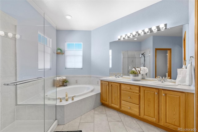 bathroom featuring a garden tub, double vanity, a sink, a shower stall, and tile patterned floors