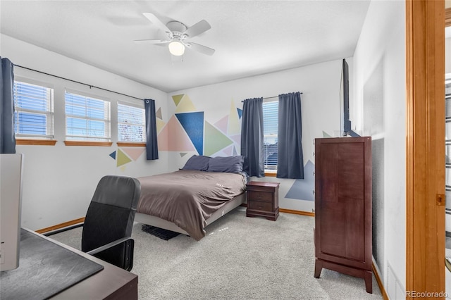 bedroom with ceiling fan, carpet flooring, and baseboards