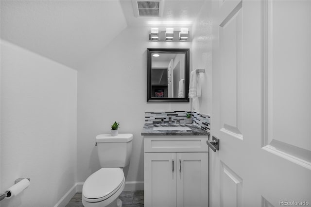 bathroom featuring baseboards, visible vents, vanity, and toilet