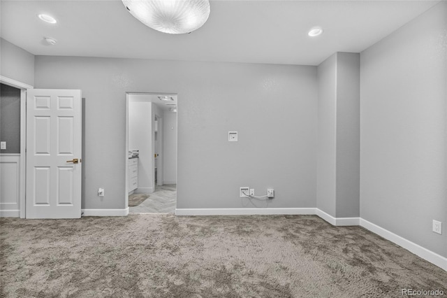 unfurnished bedroom featuring carpet and baseboards