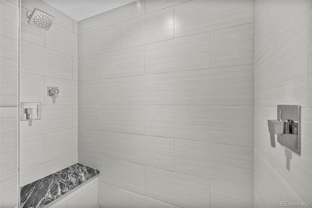 full bath with a tile shower