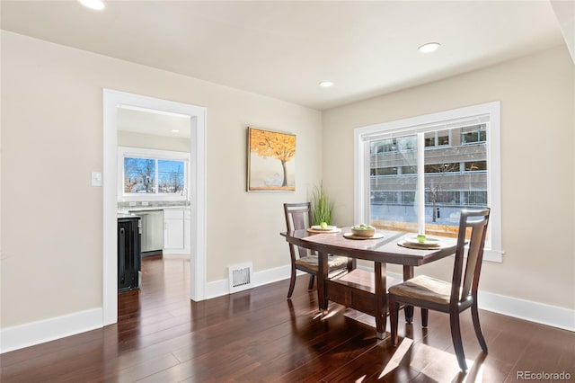 dining space with dark hardwood / wood-style floors