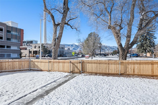 snowy yard featuring a mountain view