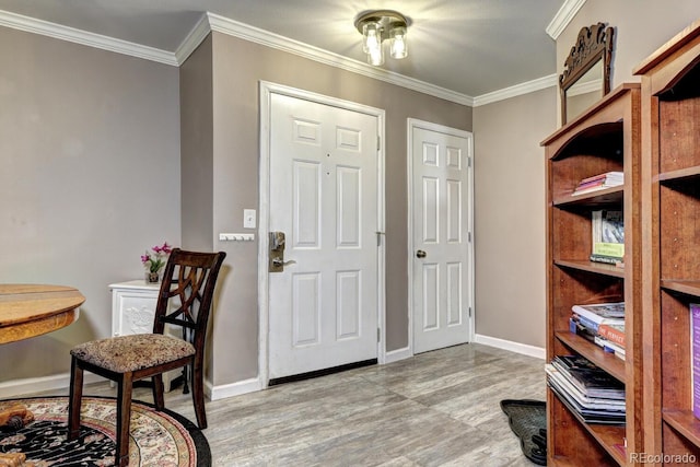 entryway with baseboards, ornamental molding, and wood finished floors