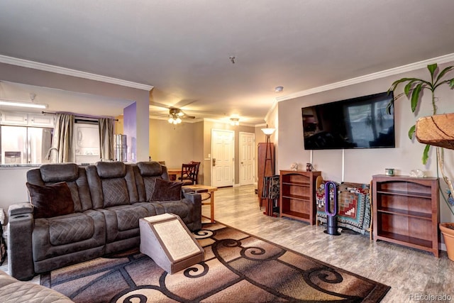 living room featuring ceiling fan, ornamental molding, and light wood finished floors