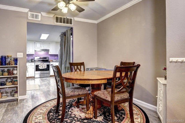 dining space with visible vents, a ceiling fan, and dark wood finished floors