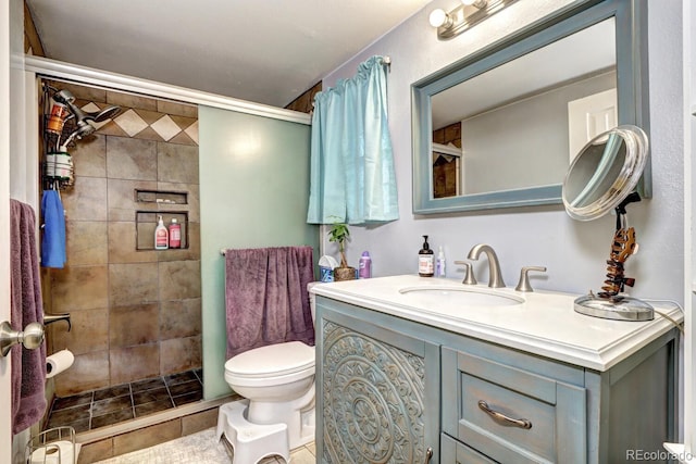 full bathroom featuring vanity, tile patterned floors, toilet, and a shower stall