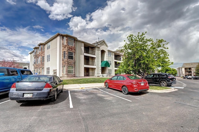 view of building exterior featuring uncovered parking