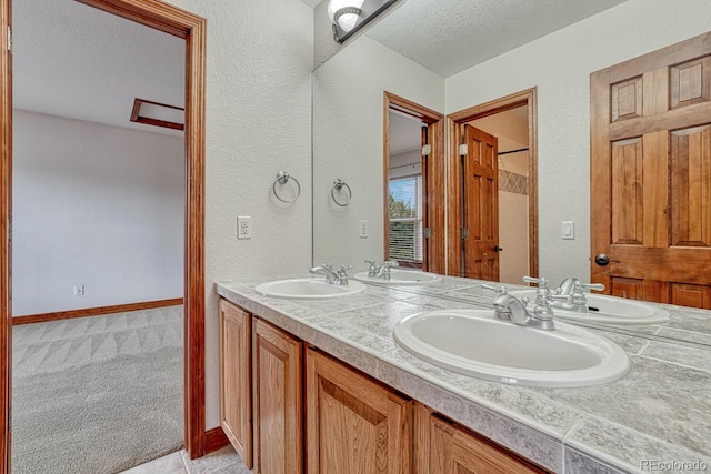 bathroom featuring a textured ceiling and a sink