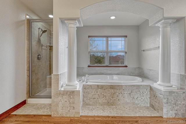 full bath featuring a shower stall, decorative columns, and a bath
