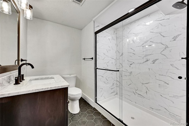 bathroom featuring vanity, a shower with shower door, toilet, and tile patterned floors