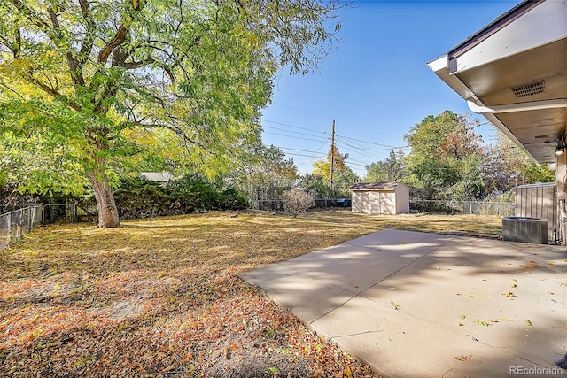 view of yard with a shed and a patio area