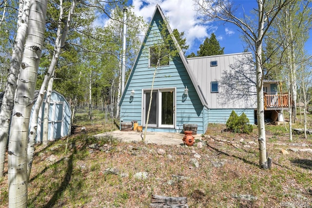 779 High Point Cir, Black Hawk, CO 80422 - back of property with metal roof and a patio area