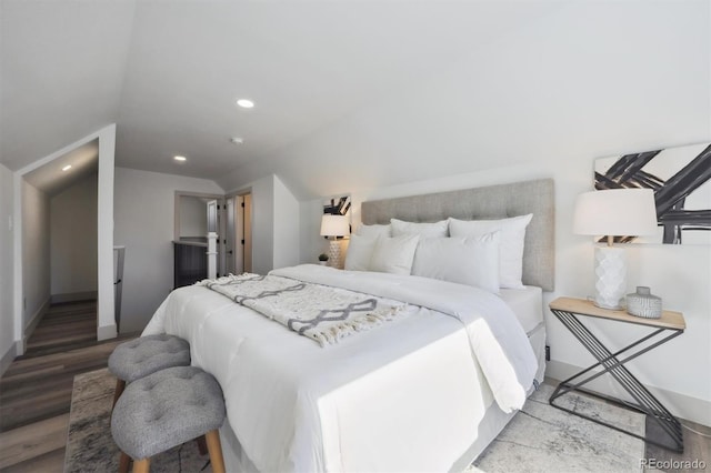 bedroom with lofted ceiling, wood finished floors, and recessed lighting