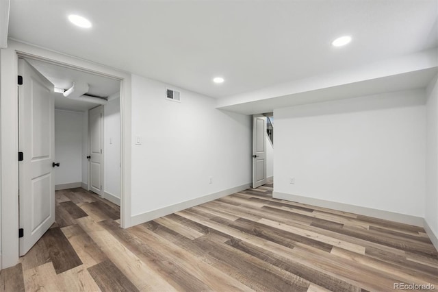 finished basement with baseboards, light wood-style flooring, visible vents, and recessed lighting