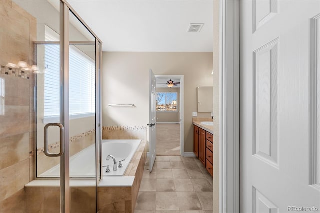 bathroom with visible vents, a shower stall, a garden tub, tile patterned floors, and vanity