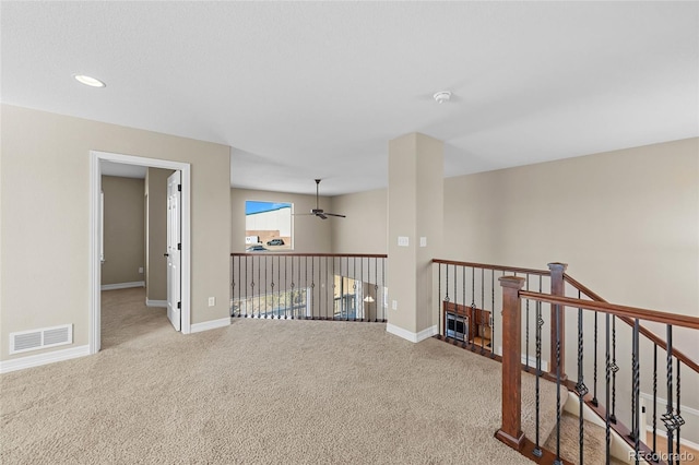 empty room featuring visible vents, a ceiling fan, recessed lighting, carpet, and baseboards