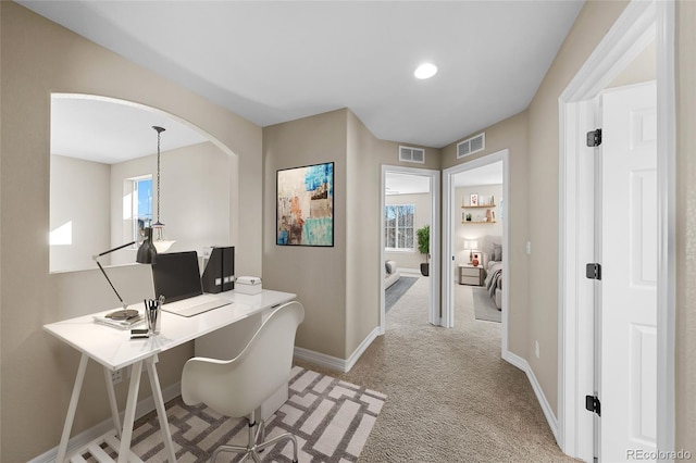 home office with visible vents, light colored carpet, and baseboards