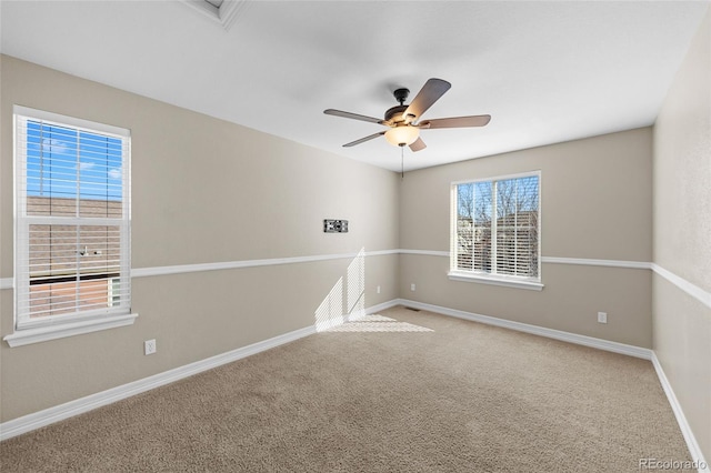 carpeted empty room featuring baseboards and ceiling fan