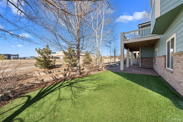 view of yard featuring a patio and a balcony