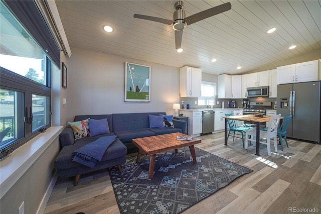 living room with wood ceiling, ceiling fan, vaulted ceiling, and light hardwood / wood-style flooring