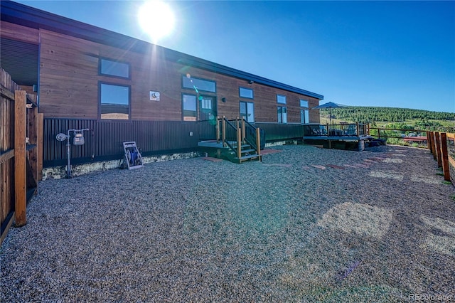 back of property with a wooden deck