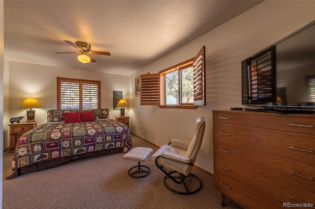 carpeted bedroom with ceiling fan and multiple windows