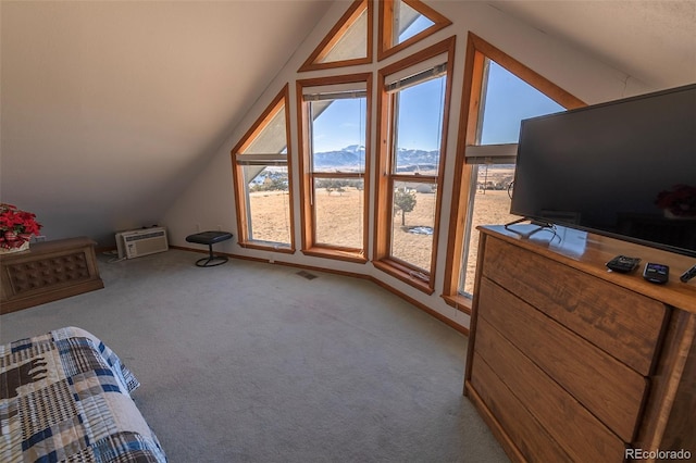 additional living space with vaulted ceiling, an AC wall unit, and carpet floors