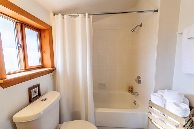 bathroom with shower / bath combo with shower curtain and toilet