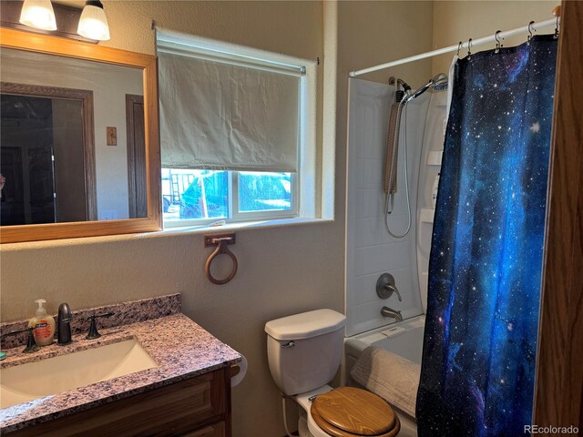 full bathroom featuring shower / bath combo, toilet, and vanity