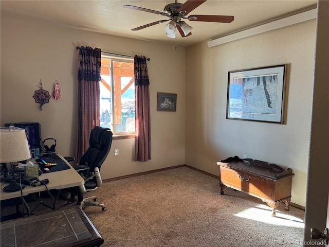 carpeted office space with ceiling fan