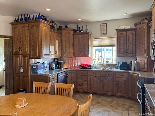 kitchen featuring sink, light tile patterned floors, and stainless steel appliances