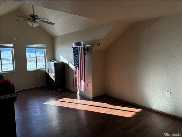 bonus room with a textured ceiling, dark hardwood / wood-style floors, ceiling fan, and lofted ceiling