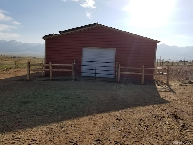 view of outbuilding with a mountain view and a rural view