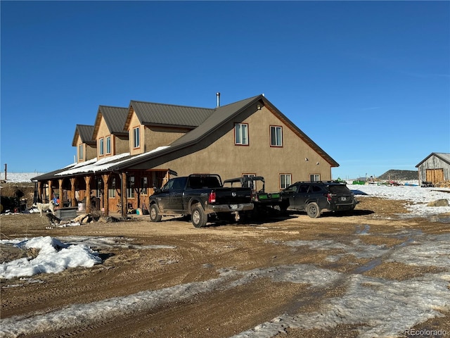 view of snow covered exterior with a porch