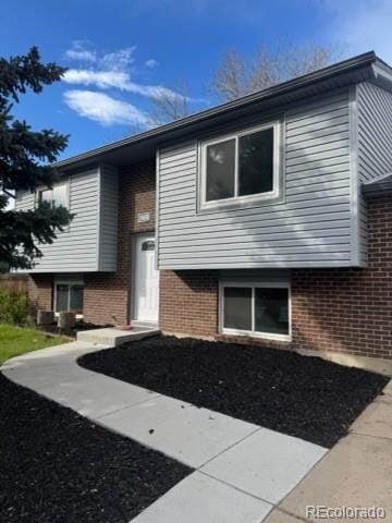 view of front of home featuring brick siding