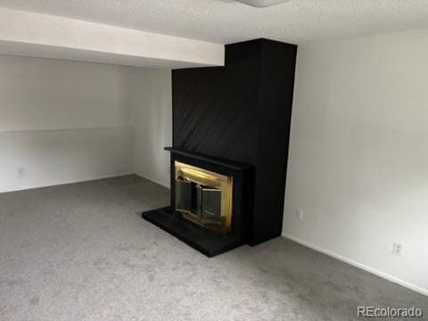 unfurnished living room featuring carpet floors and a textured ceiling