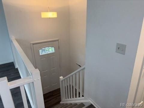 entrance foyer featuring baseboards and wood finished floors