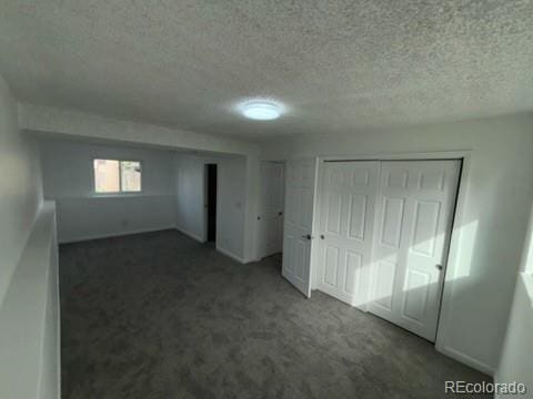 unfurnished bedroom featuring carpet flooring and a textured ceiling