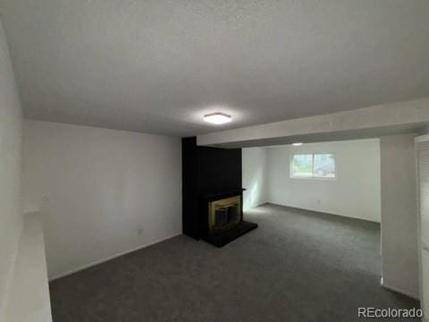 basement featuring dark colored carpet