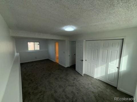 basement featuring a textured ceiling and carpet